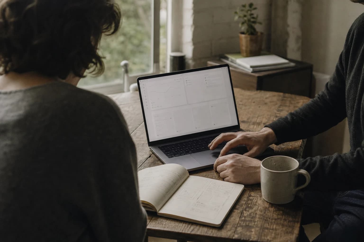 Editorial illustration: two people reviewing an application together at a worktable.